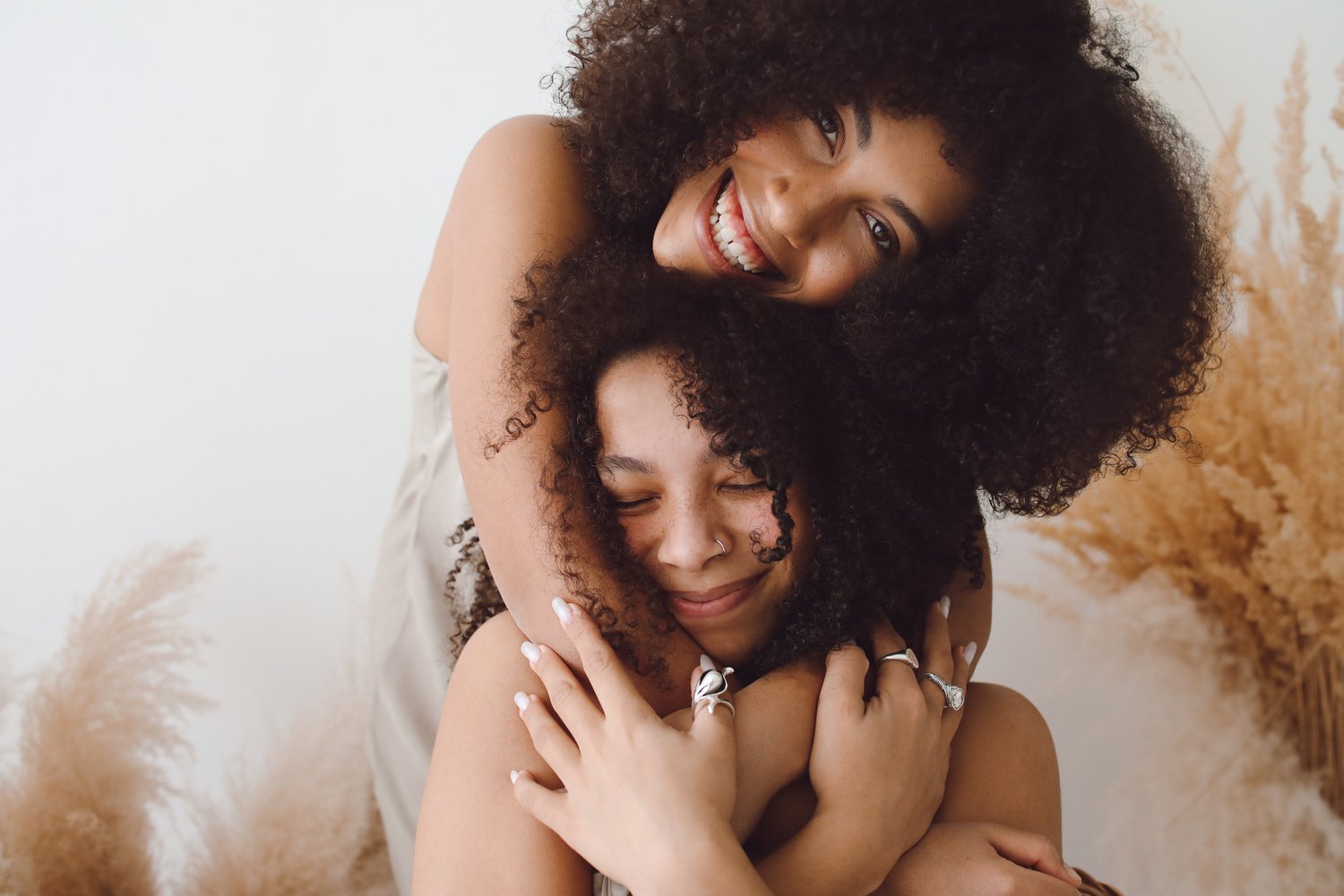 Women Embracing and Smiling